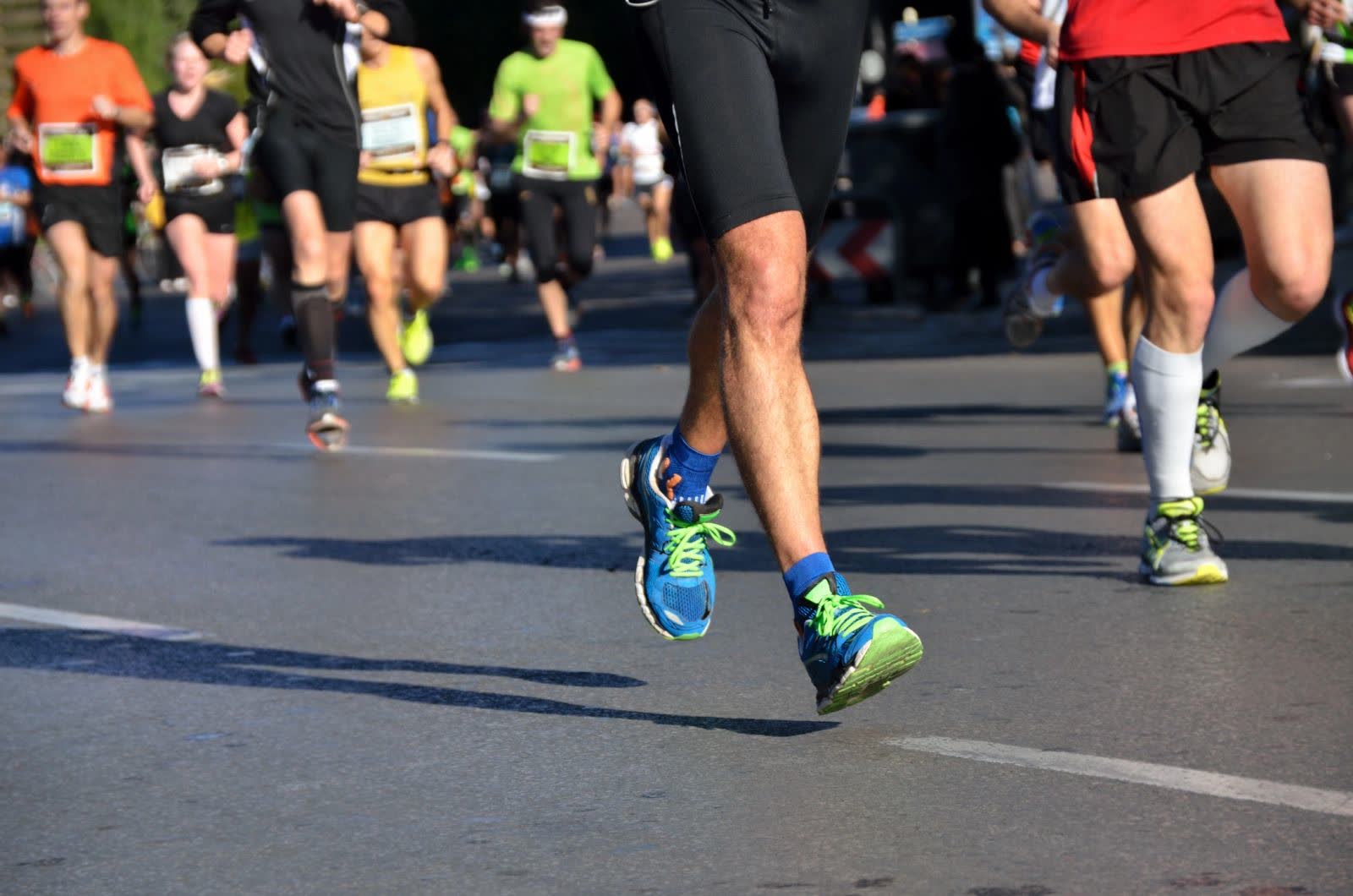 Runners’ legs mid-stride in a road race