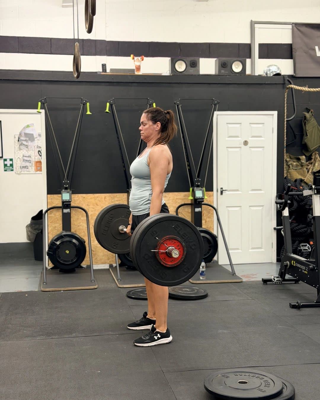 A member deadlifting a heavy barbell