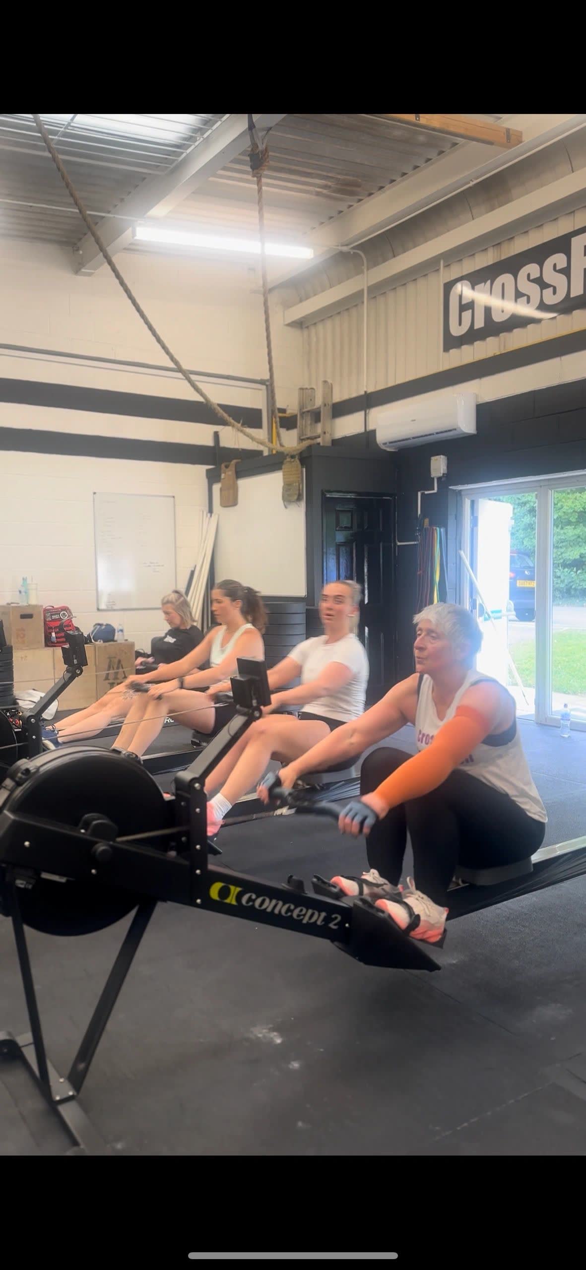 Members rowing on rowing machines in the gym