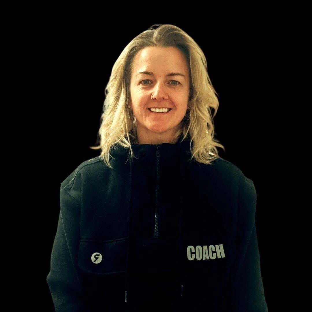 Sian, the owner, smiling in her black coach jacket