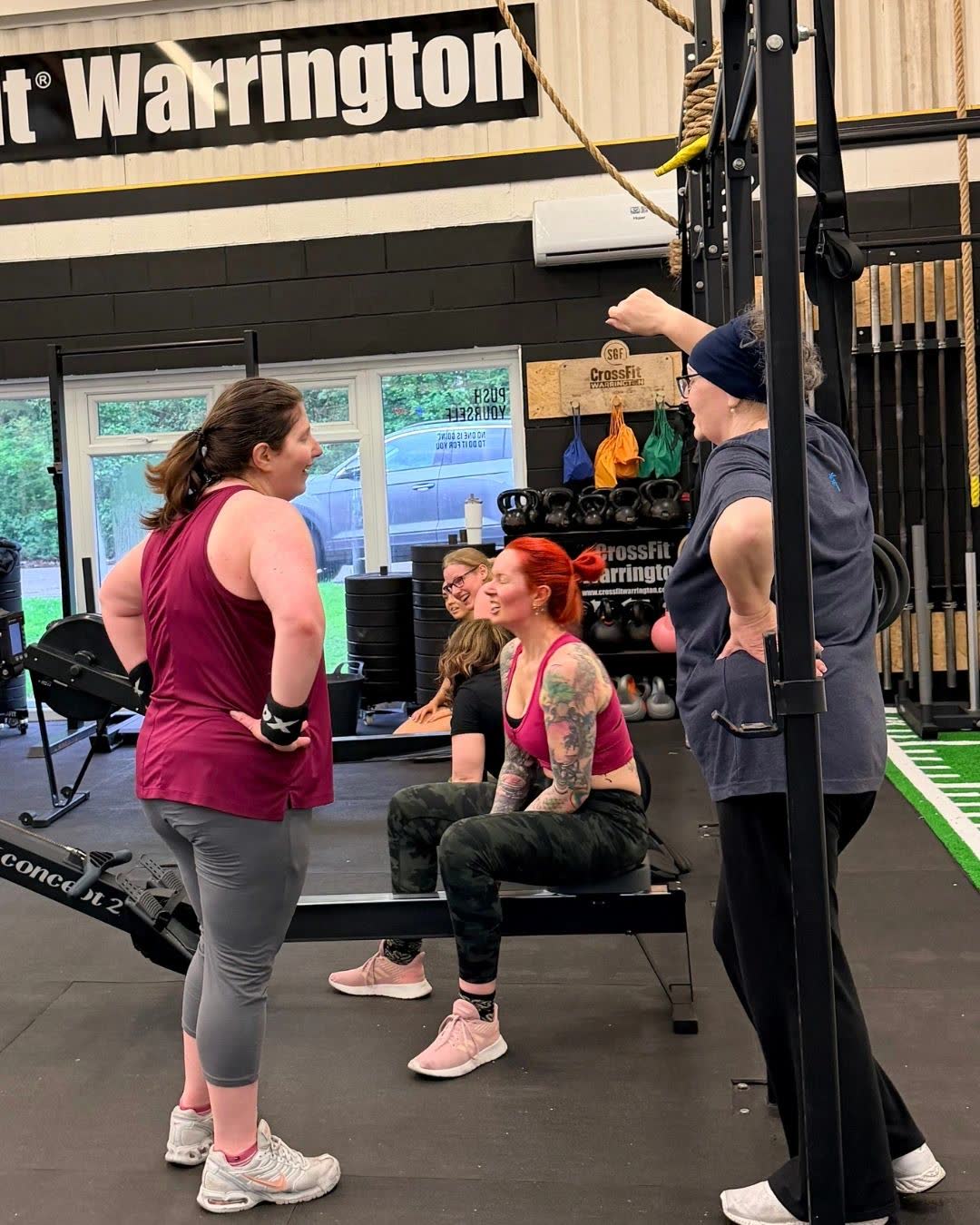 A coach with members at a bench during a beginners session