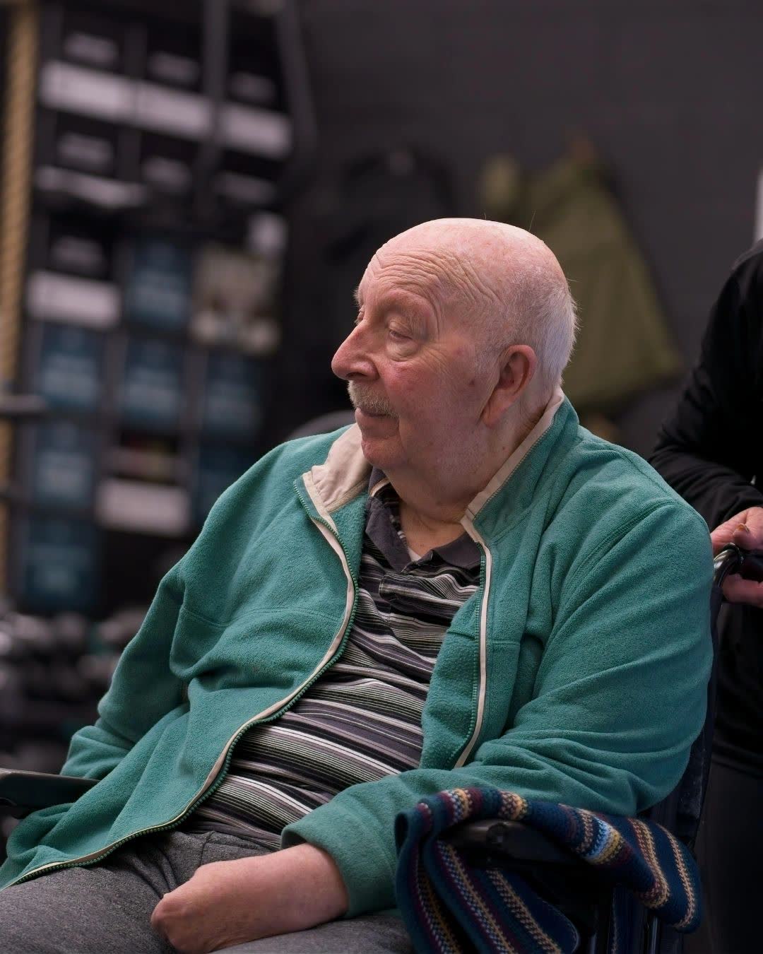 An older adaptive athlete resting between exercises