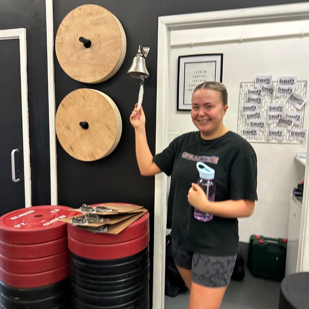 Emily ringing the gym bell