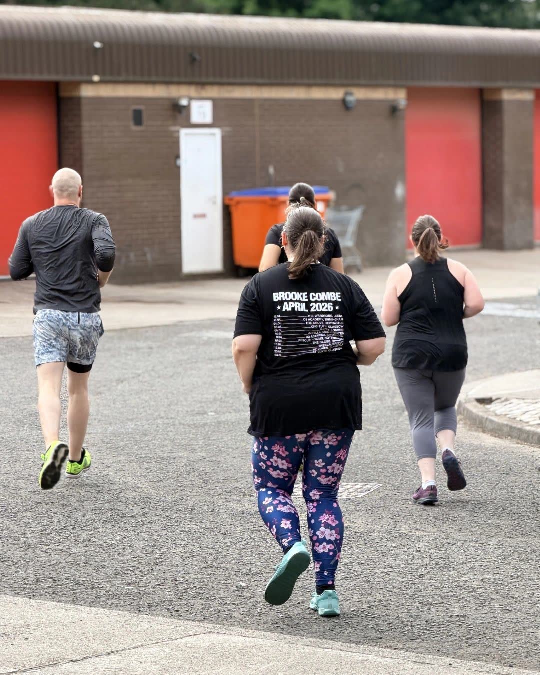 Members running together outside the gym