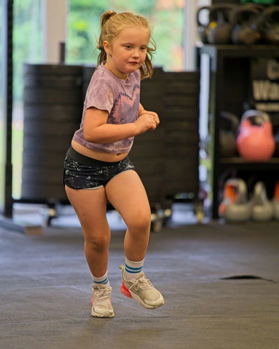 A girl running across the gym floor