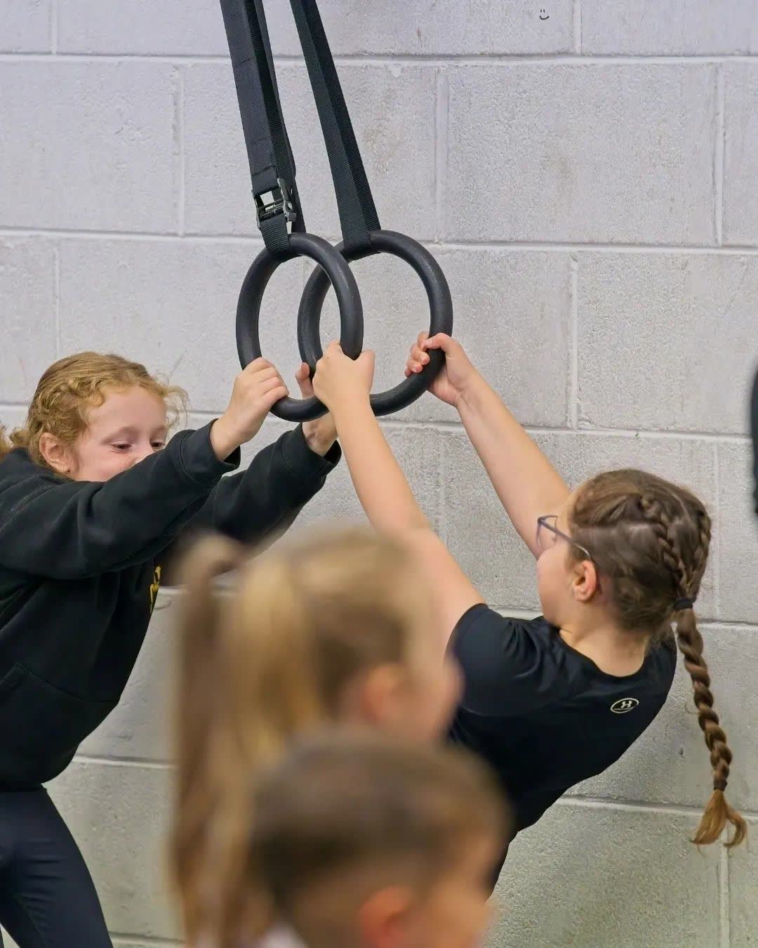 Children holding the gymnastic rings together