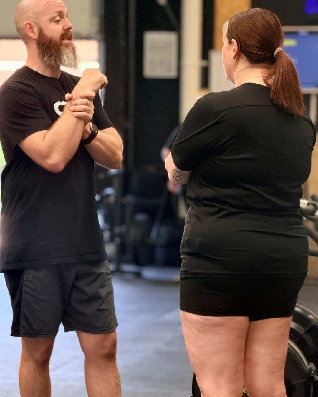 A coach talking a member through a movement