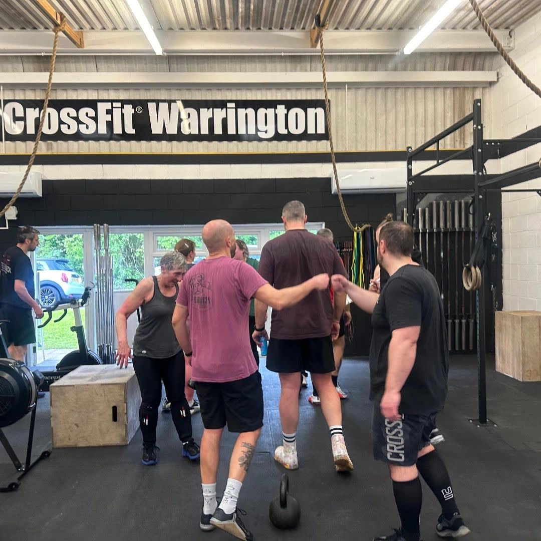 A group moving between stations in the gym