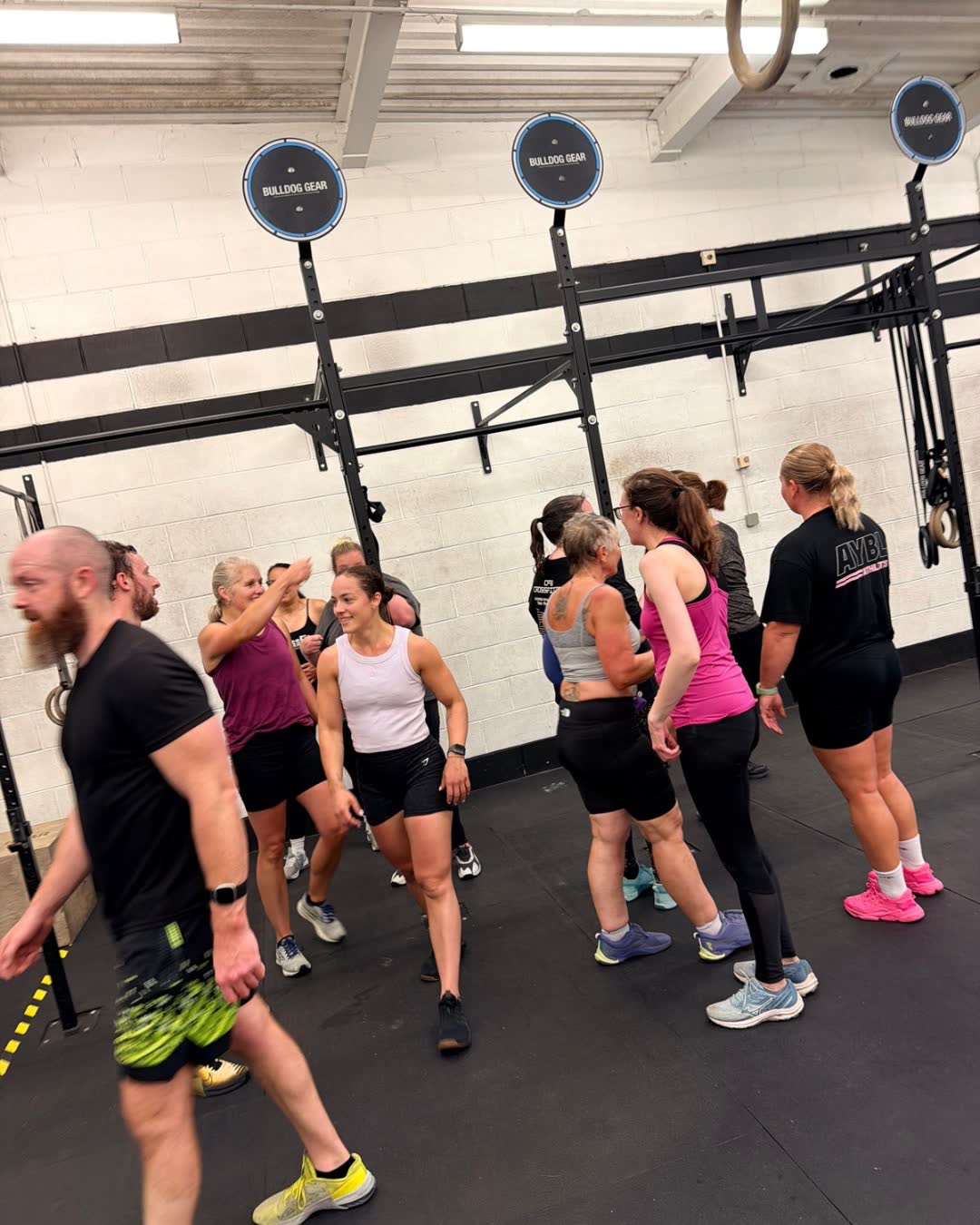 A group of members lined up ready to train in the gym