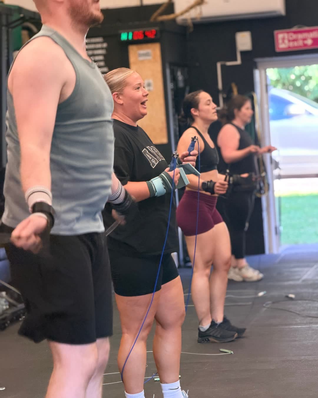 Members chatting together in the gym after a class