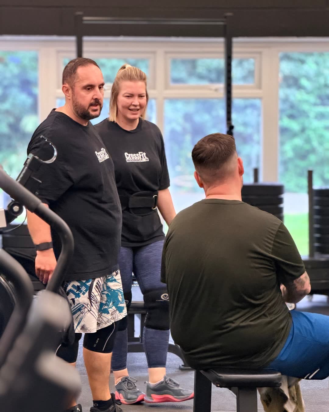 Members sharing a laugh with each other in the gym