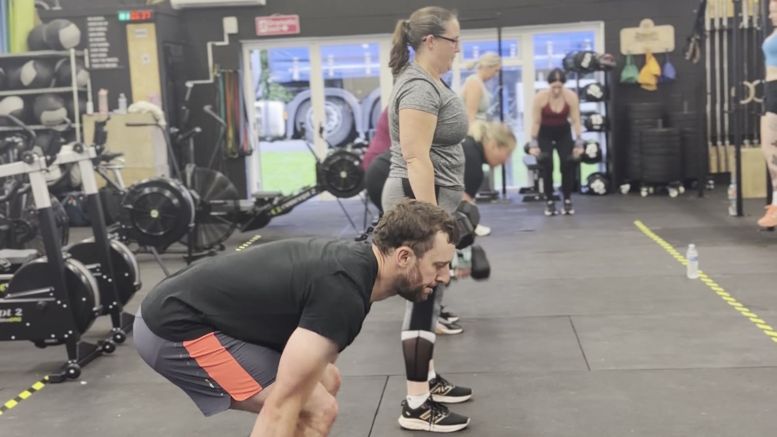 Members doing dumbbell deadlifts in a class at CrossFit Warrington